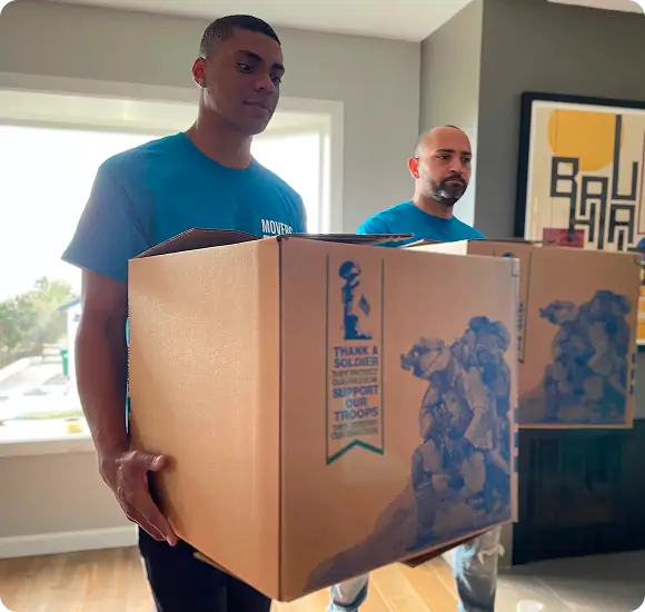 Two movers carrying moving boxes in laguna beach home
